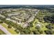 Overhead view of homes in a wooded area, showing the neighborhood's layout and surroundings at 405 E Freesia Ct, Deland, FL 32724