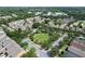 Aerial view of a well-maintained community with lush landscaping and neighborhood park at 405 E Freesia Ct, Deland, FL 32724