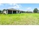 A lush, green backyard, complete with a screened-in porch, and a secure fence at 405 E Freesia Ct, Deland, FL 32724