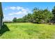Spacious backyard with lush green grass and a secure black metal fence at 405 E Freesia Ct, Deland, FL 32724