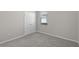 Cozy bedroom features carpet, closet, and a window at 405 E Freesia Ct, Deland, FL 32724