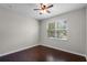 Bedroom features a ceiling fan, hardwood floors, and a window with blinds at 405 E Freesia Ct, Deland, FL 32724