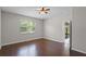 Bedroom with wood floors and a large window for natural light at 405 E Freesia Ct, Deland, FL 32724