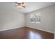 A cozy bedroom with hardwood floors and a bright window at 405 E Freesia Ct, Deland, FL 32724
