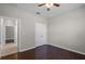 A bedroom featuring hardwood floors, ceiling fan, and a double door closet at 405 E Freesia Ct, Deland, FL 32724