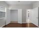 Bedroom boasts hardwood floors, closet, and double doors at 405 E Freesia Ct, Deland, FL 32724