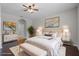 Staged bedroom with neutral colors, hardwood floors, large windows, and stylish decor, creating a relaxing atmosphere at 405 E Freesia Ct, Deland, FL 32724
