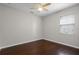 Bedroom features ceiling fan, window and hardwood floors at 405 E Freesia Ct, Deland, FL 32724