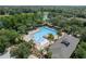 Community pool with palm trees and lounging areas, set among lush trees and landscaping at 405 E Freesia Ct, Deland, FL 32724