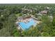 Aerial view of the community pool and splash pad, surrounded by lush greenery and offering a great space for recreation at 405 E Freesia Ct, Deland, FL 32724