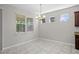 Dining area with natural light and modern chandelier, complemented by neutral walls and tile flooring at 405 E Freesia Ct, Deland, FL 32724