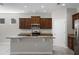 Kitchen showcasing the granite island, stainless steel appliances, wood cabinetry, and a gas cooktop at 405 E Freesia Ct, Deland, FL 32724