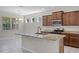 Updated kitchen with granite countertops, an island with a sink, and stainless steel appliances at 405 E Freesia Ct, Deland, FL 32724