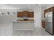 Bright kitchen with a center island, granite countertops, stainless steel appliances, and plenty of cabinet space at 405 E Freesia Ct, Deland, FL 32724