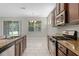 Well-lit kitchen with stainless steel appliances and granite countertops at 405 E Freesia Ct, Deland, FL 32724