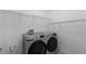 Well-equipped laundry room features shelving and a modern washer and dryer set at 405 E Freesia Ct, Deland, FL 32724