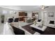 Open floor plan showcasing the living room, dining area, and kitchen with stainless steel appliances and a center island at 405 E Freesia Ct, Deland, FL 32724