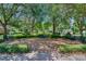 Scenic community park featuring benches surrounded by mature trees and lush landscaping at 405 E Freesia Ct, Deland, FL 32724