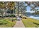 Picturesque paved walking path with views of the lake and lush green landscape at 405 E Freesia Ct, Deland, FL 32724