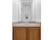 Bathroom vanity with wood cabinets, light countertop, and mirror with natural light at 4143 Calabria Ave, Davenport, FL 33897