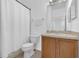 Bathroom featuring a toilet, shower with curtain, vanity, and mirror at 4143 Calabria Ave, Davenport, FL 33897
