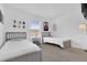 Bright bedroom featuring two twin beds with neutral colored walls and whimsical Star Wars wall decor at 4143 Calabria Ave, Davenport, FL 33897