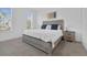 Bright main bedroom with large windows, a comfortable bed, and a stylish nightstand at 4143 Calabria Ave, Davenport, FL 33897