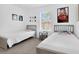 Bright bedroom featuring two twin beds, neutral walls, whimsical Star Wars wall decor, and a large window at 4143 Calabria Ave, Davenport, FL 33897
