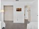 Bright bedroom featuring light, neutral colors, closet, flatscreen television, and a doorway to another room at 4143 Calabria Ave, Davenport, FL 33897