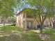 Backyard featuring a townhome with covered patio, balcony, and mature trees at 4143 Calabria Ave, Davenport, FL 33897