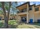 Two-story home with a balcony and patio overlooking a green space at 4143 Calabria Ave, Davenport, FL 33897