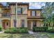Charming two-story townhome with a manicured lawn and inviting front porch at 4143 Calabria Ave, Davenport, FL 33897