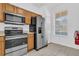 Well-lit kitchen with stainless steel appliances, wood cabinets, and tile flooring at 4143 Calabria Ave, Davenport, FL 33897