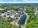 Overhead view of the neighborhood, showing lush trees and the nearby pond at 4406 Brookstone Ct, Orlando, FL 32826
