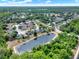 Community aerial view of neighborhood pond surrounded by homes and mature trees at 4406 Brookstone Ct, Orlando, FL 32826