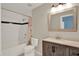 Bathroom with tub, shower, and a modern vanity with decorative mirror and lighting at 4406 Brookstone Ct, Orlando, FL 32826