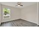 Bedroom featuring gray floors, a ceiling fan, and a window providing natural light at 4406 Brookstone Ct, Orlando, FL 32826