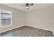 Cozy bedroom features gray wood-look floors, natural light, and neutral paint at 4406 Brookstone Ct, Orlando, FL 32826