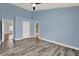 Large bedroom featuring ample natural light, wood floors, a ceiling fan and an attached bathroom at 4406 Brookstone Ct, Orlando, FL 32826
