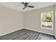 Bedroom featuring modern flooring, a ceiling fan, and a window overlooking the outdoors at 4406 Brookstone Ct, Orlando, FL 32826