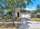 Charming single Gathering home features a 2-car garage, mature landscaping, and inviting front entrance at 4406 Brookstone Ct, Orlando, FL 32826