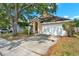 Inviting single Gathering home featuring mature landscaping, a 2-car garage, and a double wide driveway at 4406 Brookstone Ct, Orlando, FL 32826