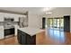 Open kitchen with a center island flows seamlessly into the living area and screened lanai at 4406 Brookstone Ct, Orlando, FL 32826