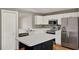 Bright kitchen boasts white cabinets, stainless steel appliances, and a convenient center island at 4406 Brookstone Ct, Orlando, FL 32826