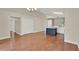 Spacious living room with wood floors flowing into open kitchen area, providing a great entertaining space at 4406 Brookstone Ct, Orlando, FL 32826