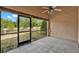 View of the screened patio with neutral paint, ceiling fan, and view of the backyard and foliage at 4406 Brookstone Ct, Orlando, FL 32826
