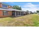 Spacious backyard with a screened patio and mature landscaping at 46 Silver Falls Cir, Kissimmee, FL 34743