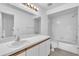 Bright bathroom featuring a white vanity, large mirror, and a shower-tub combination at 46 Silver Falls Cir, Kissimmee, FL 34743