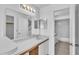 Bathroom showcasing a vanity, mirror, and access to a shower-tub, offering a clean aesthetic at 46 Silver Falls Cir, Kissimmee, FL 34743