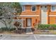 Charming townhouse with a well-maintained exterior, lush landscaping, and dedicated parking at 46 Silver Falls Cir, Kissimmee, FL 34743